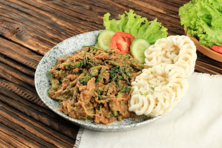 Téléchargez les photos : Lotek, Bandung West Java Salade traditionnelle saine à base de divers légumes bouillis avec sauce épicée aux arachides fraîchement broyée par le vendeur. Servi avec du riz cuit à la vapeur - en image libre de droit