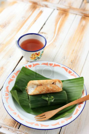 Photo for Serabi Solo. Traditional Pancakes from Solo, Central Java. Made from Rice Flour and Coconut Milk, Cooked on Traditional Earthy Pan. Rolled with Banana Leaf. - Royalty Free Image
