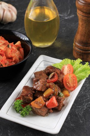 Photo for Saikoro Steak Diced Beef with Bulgogi Sauce, Served with Korean Kimchi - Royalty Free Image