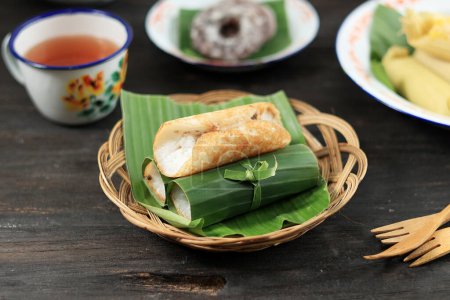 Photo for Serabi Solo Javanese Pancake, Cooked in Traditional Earthenware and Wrapped with Banana Leaf. - Royalty Free Image