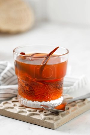Photo for Wedang Uwuh, Traditional Warm Drink with Various Spice. Usually COmes with Red Color,  On White Table - Royalty Free Image