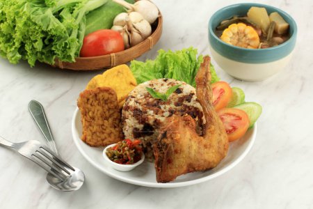 Photo for Nasi Tutug Oncom, Rice with Fermented Peanut, Served with Fried Chicken Ayam Goreng and Sayur Asem. Sundanese Traditional Cuisine, Indonesian Food. - Royalty Free Image