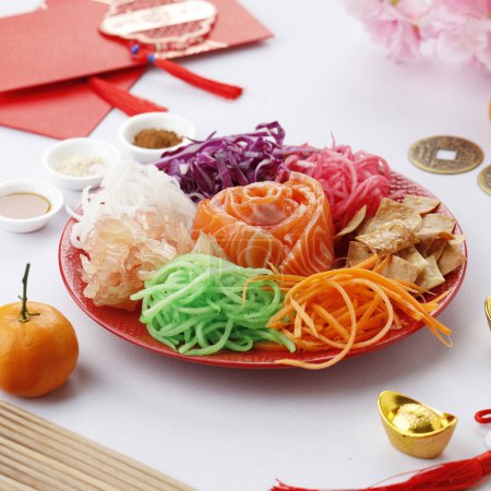 Photo for Yusheng, Yee Sang or Yuu Sahng usually Consists of Strips of Raw Salmon Fish, Mixed Shredded Vegetables, and Sauces and Condiment - Royalty Free Image