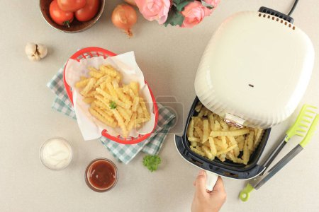 Female Hand Take Out Airfryer Tray Machine Ccooking. Grilled Potato French Fries, No Oil Cooking 