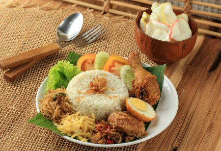 Photo for Nasi Uduk Betawi, Steamed Rice Coconut Milk, Seved with Various Side Dish. Popular for Breakfast in Jakarta, Indonesia - Royalty Free Image