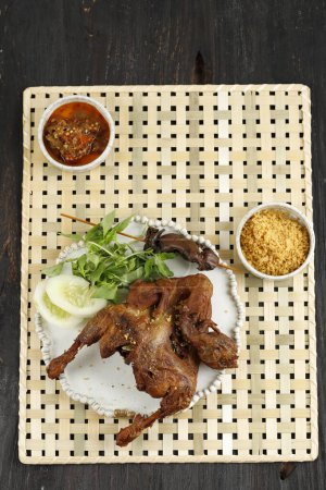 Photo for Top View Bebek Goreng Kremes, Fried Duck with Crispy Flour Batter. Served with Fresh Vegetable and Sambal - Royalty Free Image