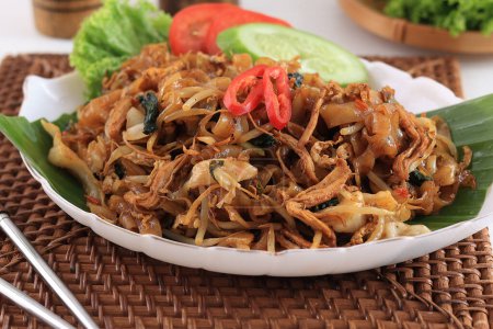 Photo for Kwetiaw or Kwetiau Char Kway Teow, Fried Flat Rice Noodles with Chicken, Meatballs, and Various Vegetables. Popular Chinese Food in Indonesia - Royalty Free Image
