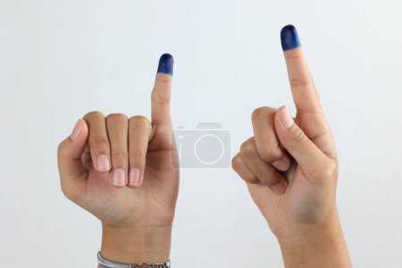 Téléchargez les photos : Main FInger femelle avec encre bleue sur fond blanc. L'encre bleue des doigts de l'élection présidentielle indonésienne - en image libre de droit