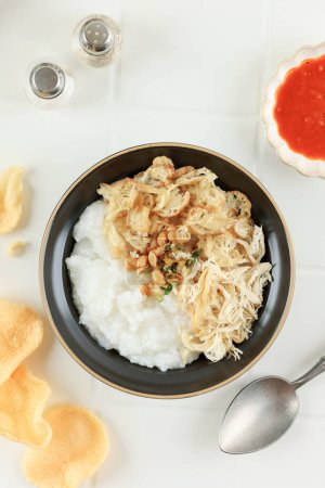 Photo for Top View Bubur Ayam or Chicken Porridge, Indonesian Traditional Food Consist of White Rice Porridge, Shredded Chicken, Cakwe, Fried Soybean, and Green Onion - Royalty Free Image
