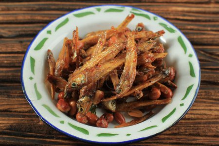 Photo for Close Up Sambal Balado Teri Kacang, Fried Anchovy and Peanut Stir Fry with Sweet and Spicy Chilli Sauce until Caramelized. Indonesian Daily Menu - Royalty Free Image