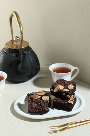 Photo for Slice Fudge Brownie with Almond Flake and Chocolate Chips, Tea Time Concept - Royalty Free Image