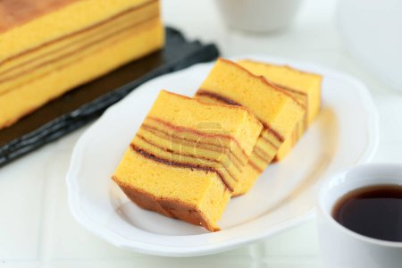 Sliced Lapis Philipine or Legit Filipin, Thousand Layer Cake with Sponge Cake, on White Plate 