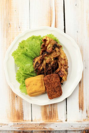 Top View Cumi Bakar or Roasted Squid with Tofu and Tempeh, on White Plate