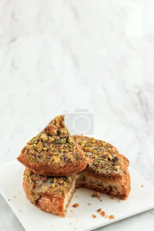 Kouign Amann Pastry, Sweet Breton Cake with Chopped Pistachio. Made from Laminated Dough Multi Layered Pastry