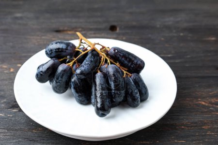 Purple Witch Finger Grapes or Sapphire Grape on White Plate