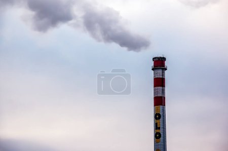 Photo for Bratislava, Slovakia - 01.12.2024: Oil refinery. Pipe with smoke against the sky. - Royalty Free Image