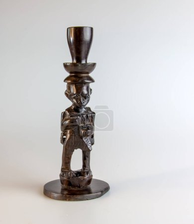 African figurine candlestick made of ebony on a white background.