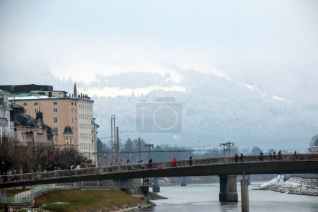 Photo for Salzburg, Austria - 01.13.2024: View on the Marko-Feingold-Steg bridge over the Salzach river in the city of Salzburg, Austria. - Royalty Free Image