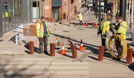 Photo for Dnepr, Ukraine - 02.15.2022: Workers are laying cables on a city street. - Royalty Free Image