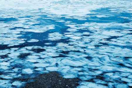 Vector illustration of an icy river surface. Texture of ice and water fragments. Winter background.