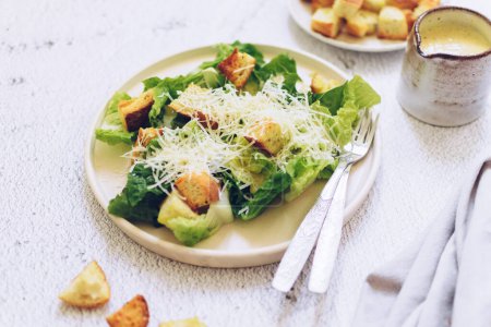 Classic caesar salad with lettuce, croutons and parmesan cheese. Caesar salad. Vegetarian tasty food recipe for cookbook. Diet fitness menu. High quality photo.