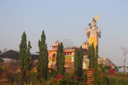 Giant Shiva statue towering over scenery