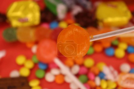 Photo for A focus red lollipop with the background chocolate - Royalty Free Image