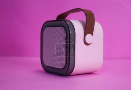 Cool mini bluetooth speaker on the pink background
