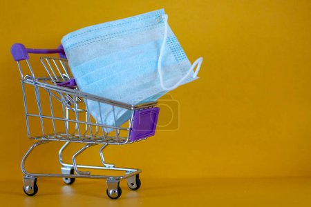 Photo for Protective mask , store trolley. Shortage of medical supplies. Demand, sales growth for medicines and protective equipment. - Royalty Free Image