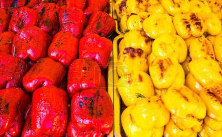 Photo for Har grilled red and yellow bell peppers, cooked on the grill, street food closeup.  grilled vegetables on the town picnic. red beautiful pepper before preparation on a grill. - Royalty Free Image