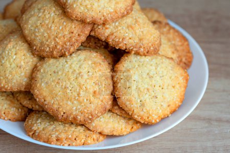 Sesame cookies on a plate. Pile, heap of sesame cookies.  Delicious and sweet sesame cookies. Homemade baking concept