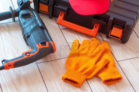 Top view of Working tools.rotary hammer, tool box, work cap, gloves. Worker gear concept