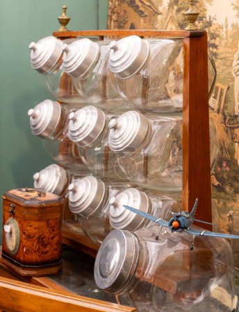 sideboard, display case with large glass jars for candy in an antique store