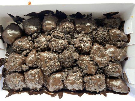 a portion of melted chocolate banana nuggets in a paper lunch box