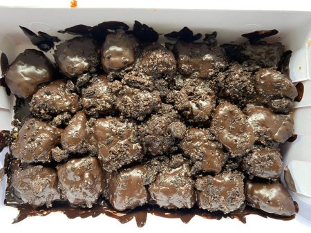 a portion of melted chocolate banana nuggets in a paper lunch box