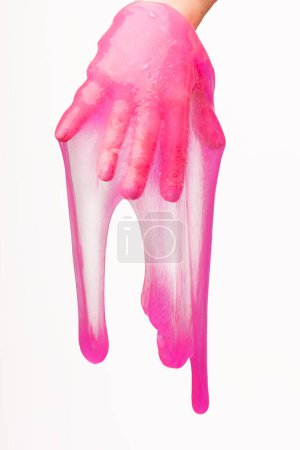 a toy for children mucus and liquid flowing on hand on a white background