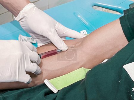 Téléchargez les photos : Une infirmière injecte un analgésique dans la main d'un patient. - en image libre de droit