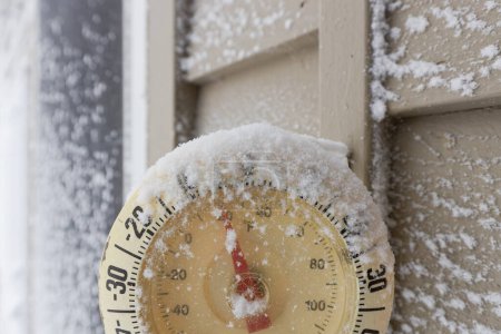 Photo for Snow Capped Thermometer Mounted on Wooden House Siding with Freezing Temperature. High quality photo - Royalty Free Image