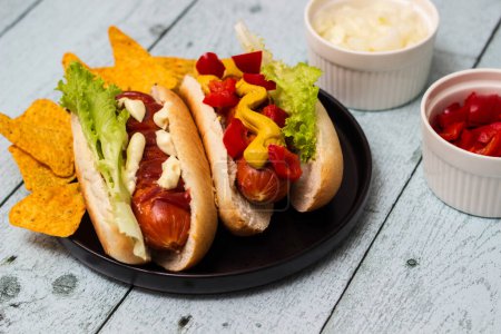 Hot dogs with different toppings on a table
