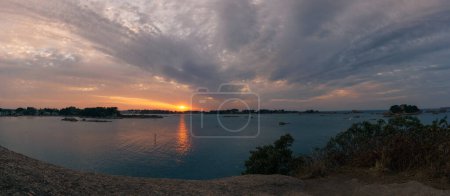 Photo for Panorama of bay Sainte-Anne near Ploumanac'h during sunset on summer evening with islands and Chateau Coastares, Cote de Granit Rose Brittany , France - Royalty Free Image