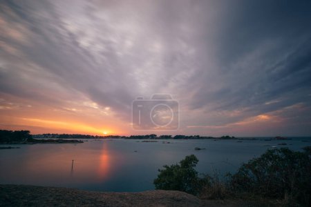 Photo for Long exposure of evening sky with clouds of bay of Ploumanac'h during sunset on a summer evening with islands, Cote de Granit Rose Brittany , France - Royalty Free Image