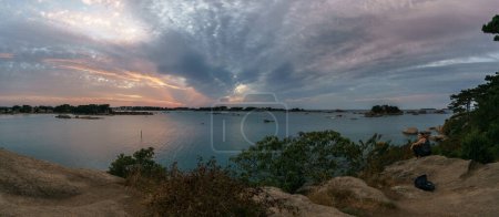 Photo for Panorama of bay of Ploumanac'h during sunset on a summer evening with islands and Chateau de Coastares, Cote de Granit Rose Brittany , France - Royalty Free Image