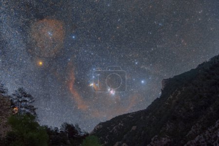 Photo for Night sky with Orion Constellation over mountain landscape with Barnards Loop, Orion, Flame and Rosette Nebula, Pyrenees, Aragon, Huesca, Spain - Royalty Free Image