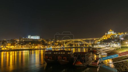 Photo for Night view at Ponte Dom Luis, Ribeira do Porto and Cathedral with boats on Douro from Vila Nova de Gaia , Porto, Portugal - Royalty Free Image