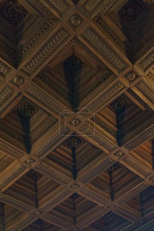 Detail of a brown wooden ceiling with quadratic shape in Alhambra, Granada, Andalusia, Spain