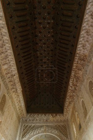 Beautiful wooden ceiling and detailed artwork on white walls, Granada, Andalusia, Spain