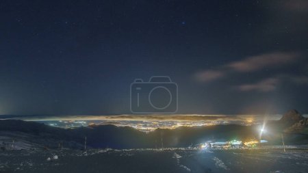 View at the city of Granada during nighttime seen from Sierra Nevada mountains, Andalusia, Spain