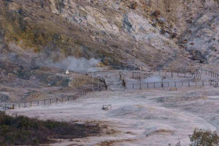 Landscape of Solfatara at Campi Flegrei near Naples at evening with smoke and steam coming out the ground, Pozzuoli, Campania, Italy