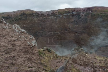 Landscape on top of the crater of dormant Vesuvius volcano with smoke rising out of the rocks, Naples, Campania, Italy