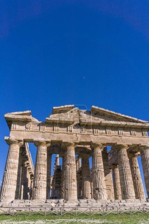 Detail view of Temple of Hera with moon above at famous Paestum Archaeological UNESCO World Heritage Site, Province of Salerno, Campania, Italy